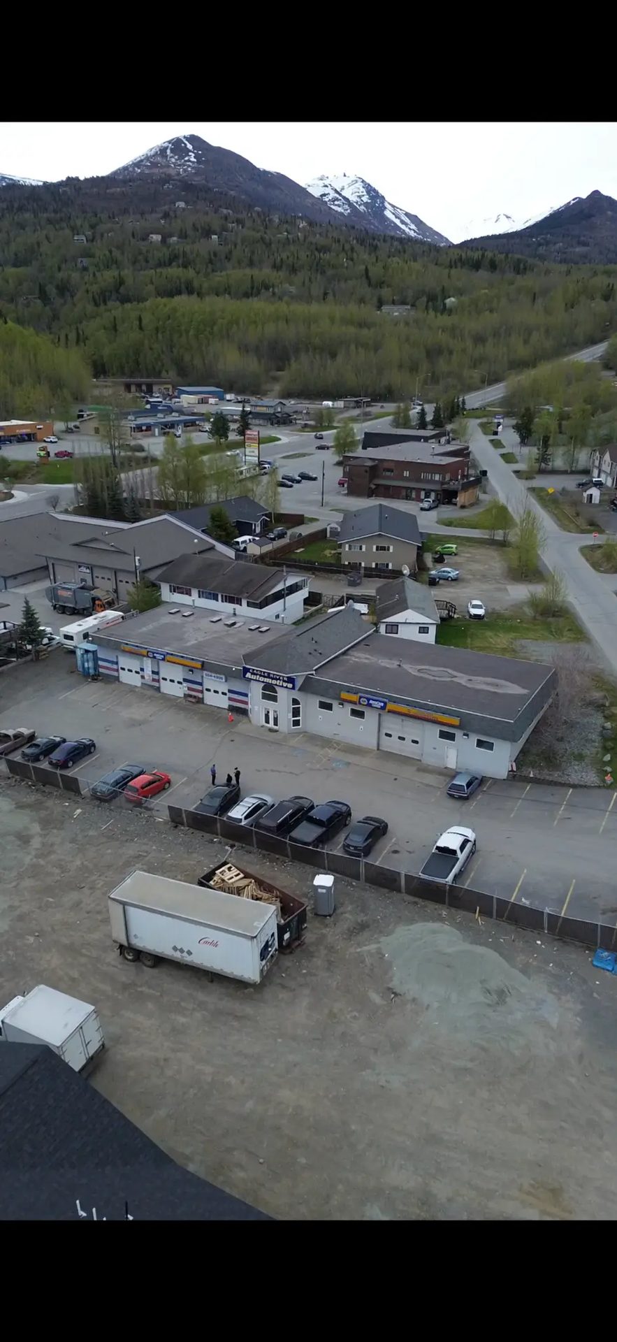 Aerial view of Eagle River Automotive with the Chugach Mountains behind
