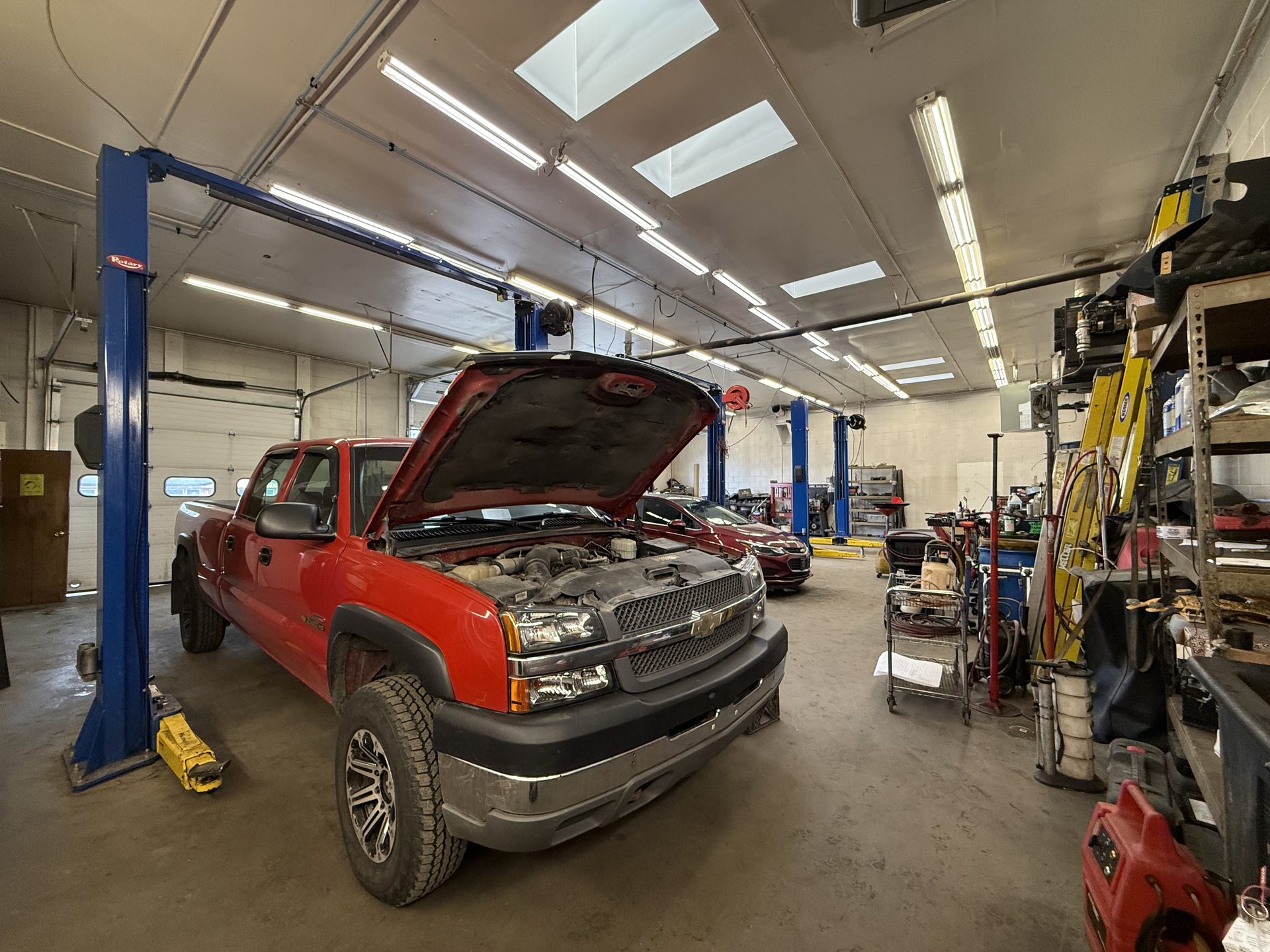 A truck on the lift inside the Eagle River Automotive service bay